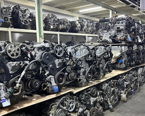 Row of tested used engines and gearboxes ready for sale at Sell Any Car Scrap UAE yard in Al Sajaa, Sharjah.